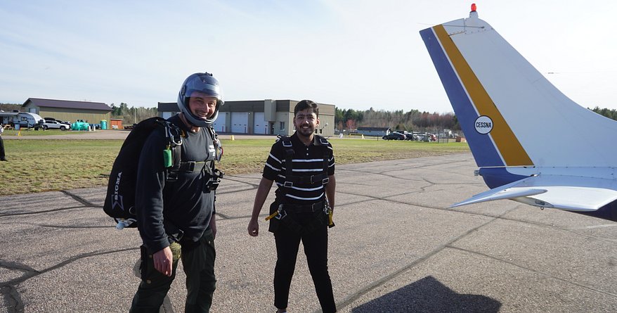 skydivers walk to airplane in ontario canada c182